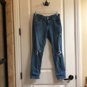 Low rise boyfriend jeans with rips in the knees